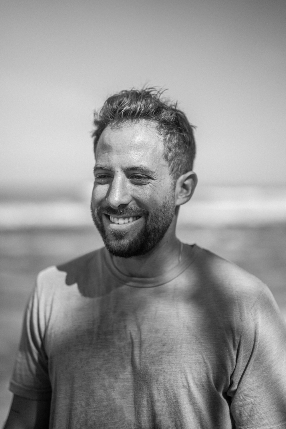 Black and white portrait of Ben Lee laughing